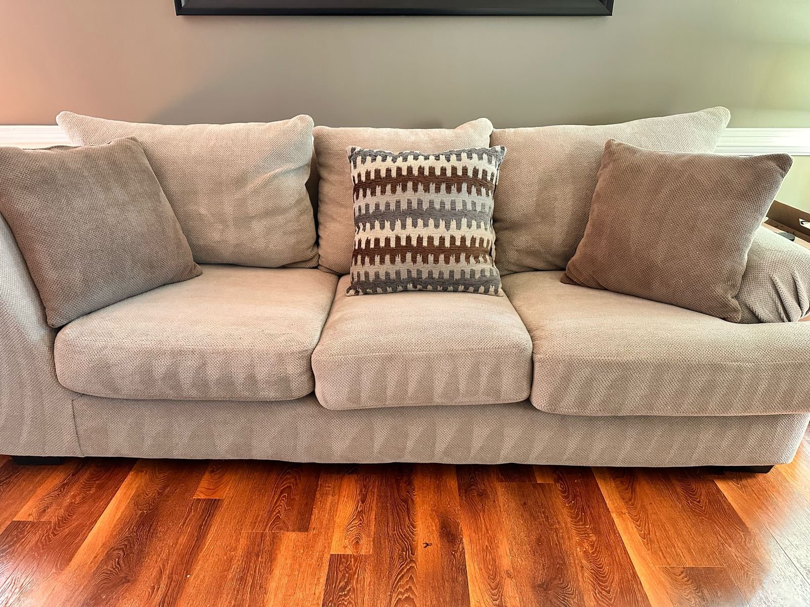 Living room cleaned by Dyment Cleaning Service: sofa cushions straightened and hardwood floor vacuumed